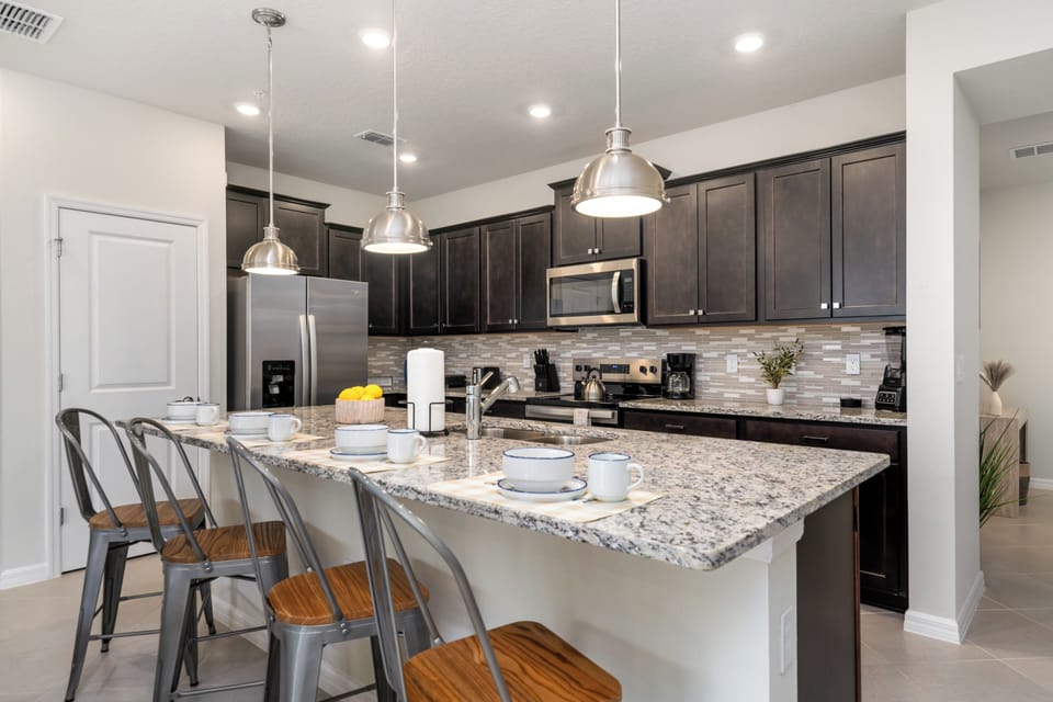 Fully-equipped kitchen with stainless steel appliances.