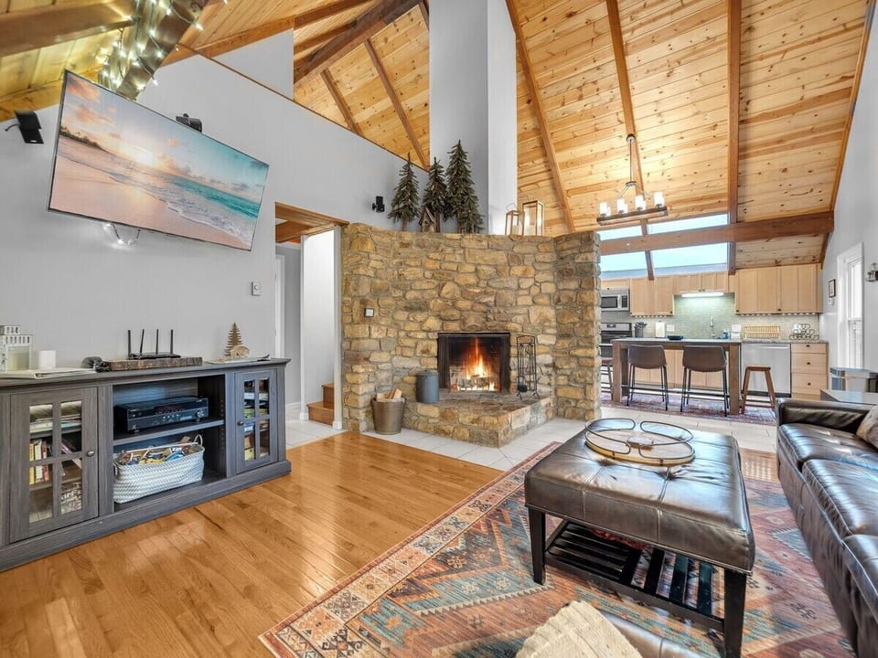 Stacked Stone Gas Fireplace, Vaulted Tongue and Groove Ceiling TV in the Living Room