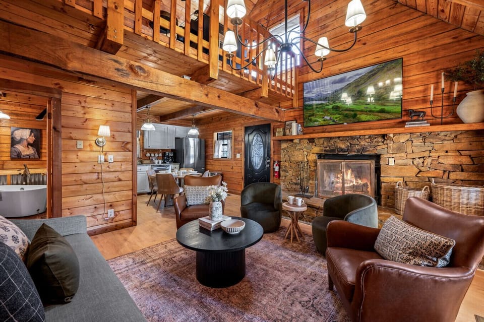 Cozy living room with fireplace, vaulted ceilings & plush seating for fun!