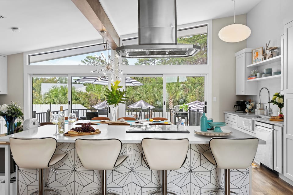 Kitchen features an island with barstool seating.