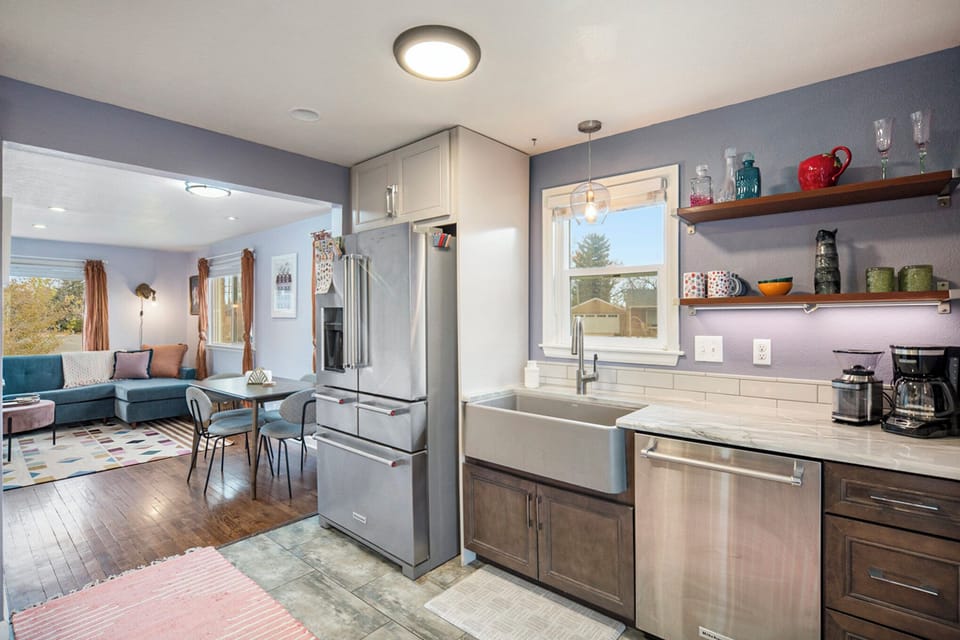 Spacious and inviting, the open floor plan seamlessly connects the living, dining, and kitchen areas, perfect for gathering and entertaining.
