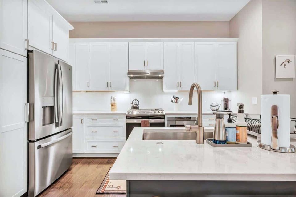 Cook like a pro in this bright, modern kitchen with sleek appliances, spacious counters, and everything you need to create and entertain with ease.