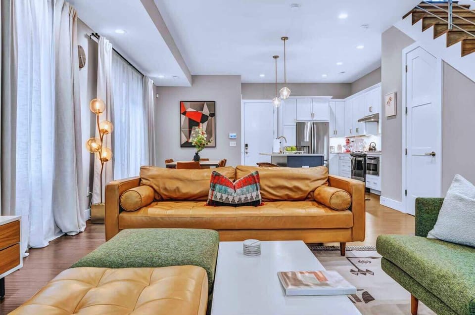 This bright, stylish space blends bold decor with cozy touches. Sink into the leather sofa, gather around the table, and enjoy every moment in this vibrant home base!