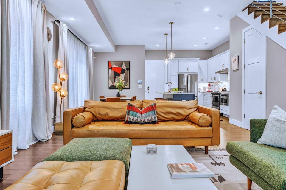 This bright, stylish space blends bold decor with cozy touches. Sink into the leather sofa, gather around the table, and enjoy every moment in this vibrant home base!