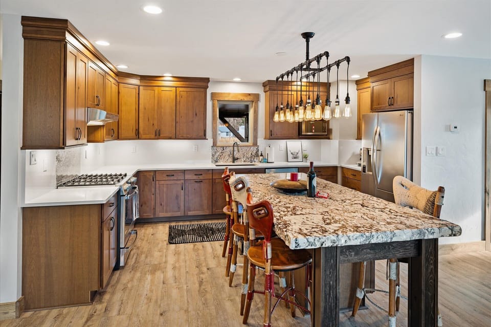 Cook in style with this fully equipped kitchen featuring rustic charm, a spacious island, and modern appliances to meet all your culinary needs.