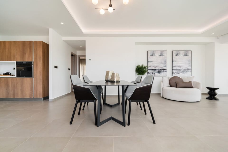 Enjoy meals in the dining area, with an outside view towards the sea