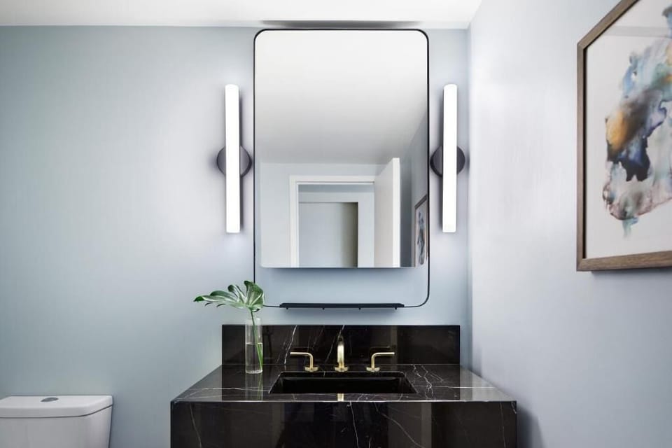 Refresh at a sleek vanity with bright, flattering lighting.