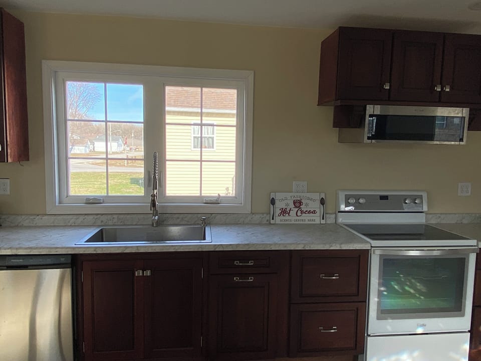 Fully stocked kitchen with stove, cookware and utensils. Dishwasher, fridge