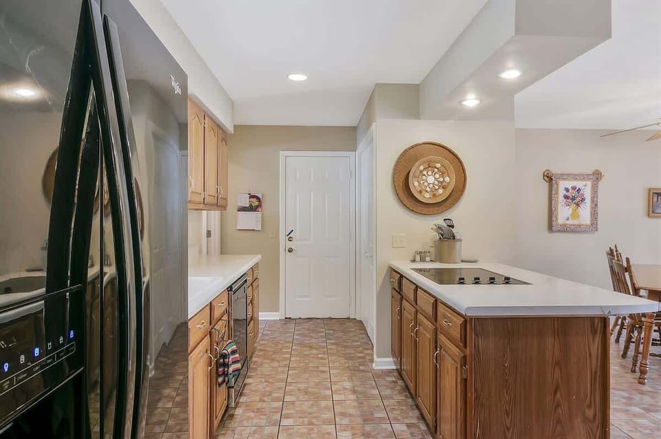 Fully equipped kitchen with warm wooden cabinets and a central island.