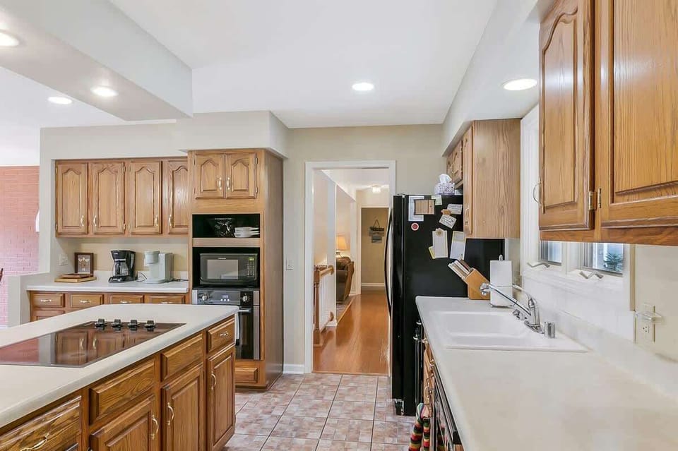 Spacious kitchen with abundant counter space, warm wood cabinetry, and everything needed to prepare meals for the whole group.