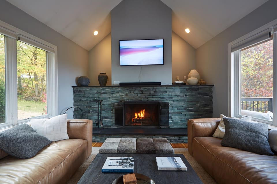 Cozy up by the stunning stone fireplace and unwind in our spacious, modern living room.