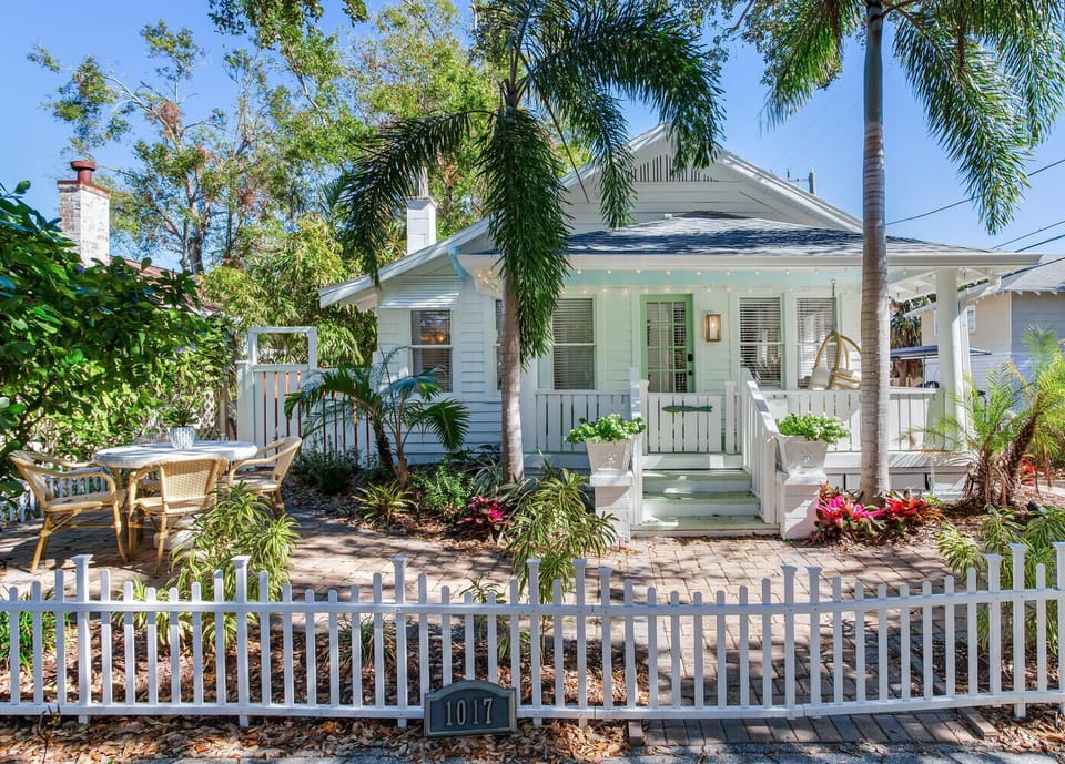 Fully fenced front yard. Dining area for 4. Covered porch sofa and chair swing