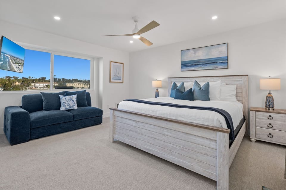 Spacious primary suite featuring a luxurious King-size plush mattress and a comfortable sofa.