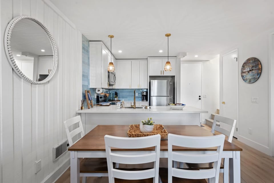 The charming wooden dining table comfortably seats 6, offering a cozy space for shared meals and conversations