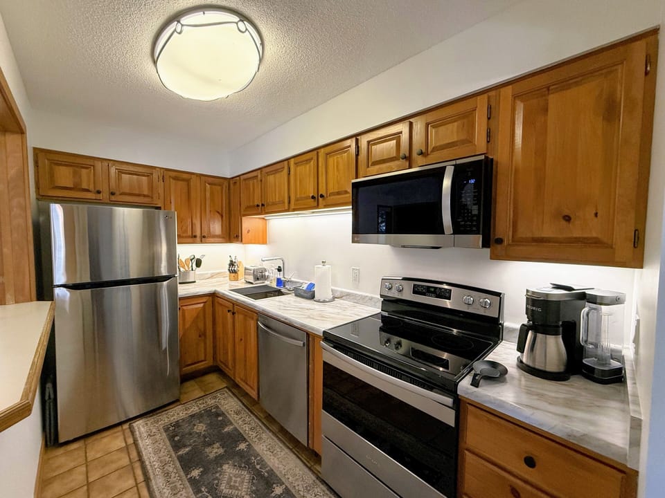 The kitchen may be compact, but it's thoughtfully designed with modern appliances and everything you need to prepare a delicious home-cooked meal.