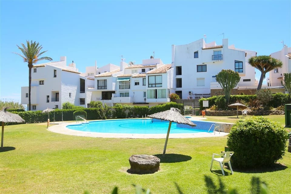 Inviting communal pool surrounded by beautiful gardens