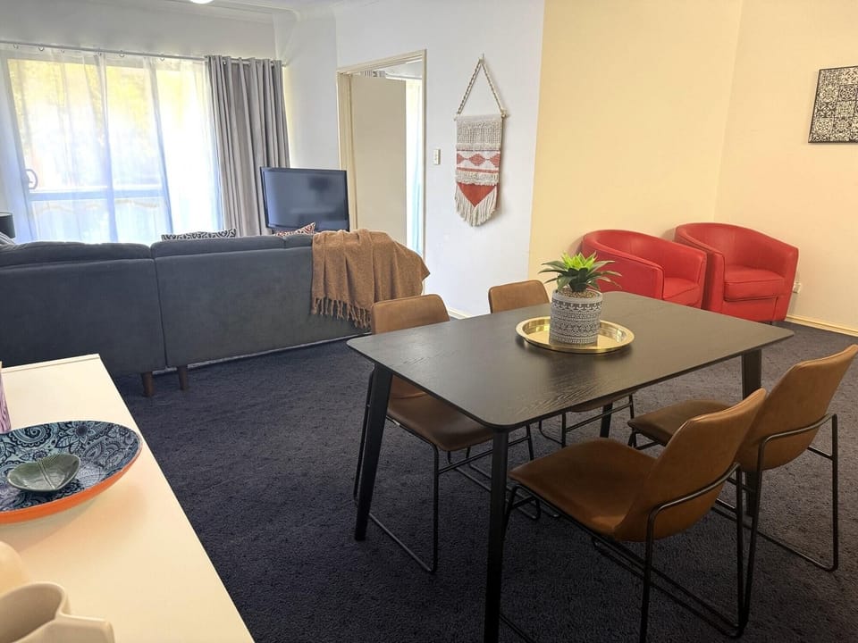 This apartment features a bright and living and dining area. Unwind on the comfortable living room sofa while enjoying the television, and gather around the dining table that comfortably seats 4 and is equipped with air conditioning.