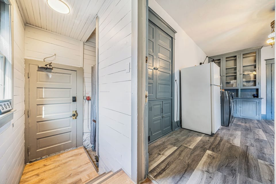 - Welcoming back entrance connects directly to the kitchen and laundry area   - Wood details and natural light highlight the clean, modern design   - Designed for both comfort and practical everyday living