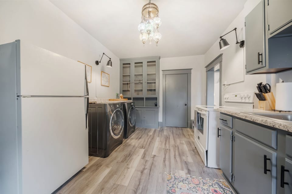 - Cook and clean easily in a fully equipped kitchen with modern appliances and washer-dryer   - Spacious layout offers ample counter space for meal prep convenience   - Perfect blend of function and style with soft gray cabinetry and wood floors