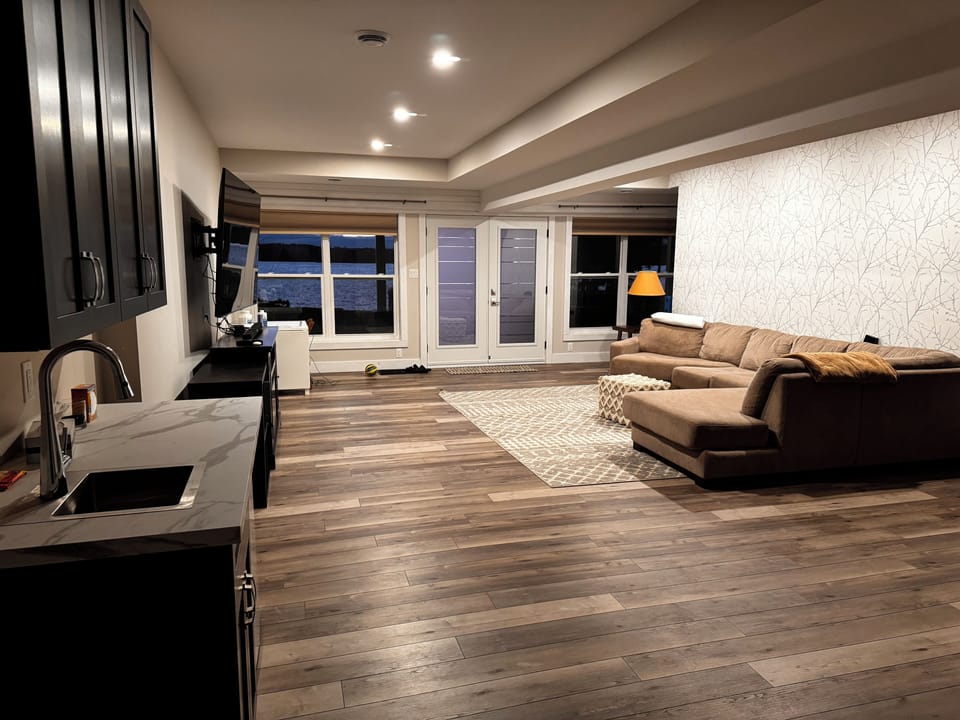 Lower level living space with entertainment unit and bar