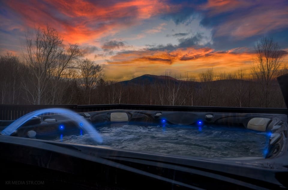 The upper deck hot tub with mountains in the background. One guest called it simply breathtaking. We agree.