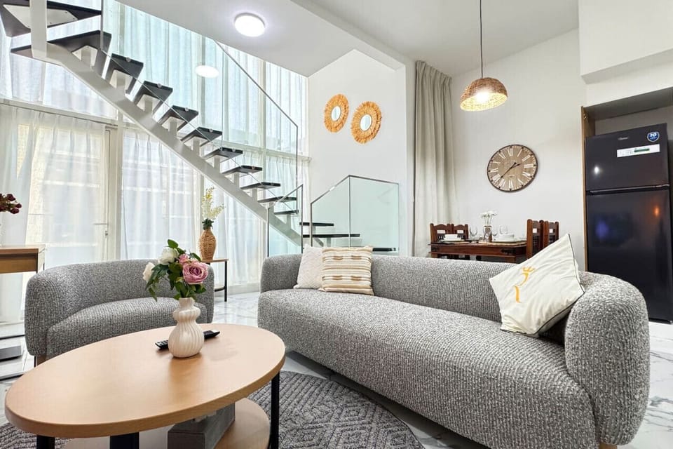 Unwind in a spacious, beautifully decorated living room with plush seating, high-end finishes, and ambient lighting – a perfect space for unwinding after a day of exploring.