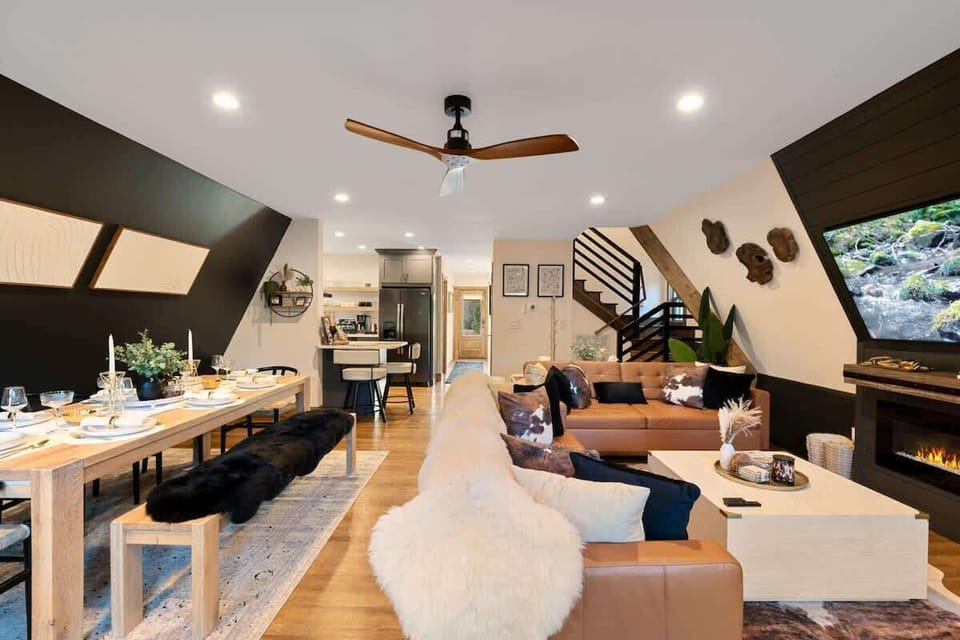 Experience the seamless flow of our open-concept living space, featuring a dining area, living room with fireplace, and a modern kitchen. Enjoy the perfect blend of comfort and style.