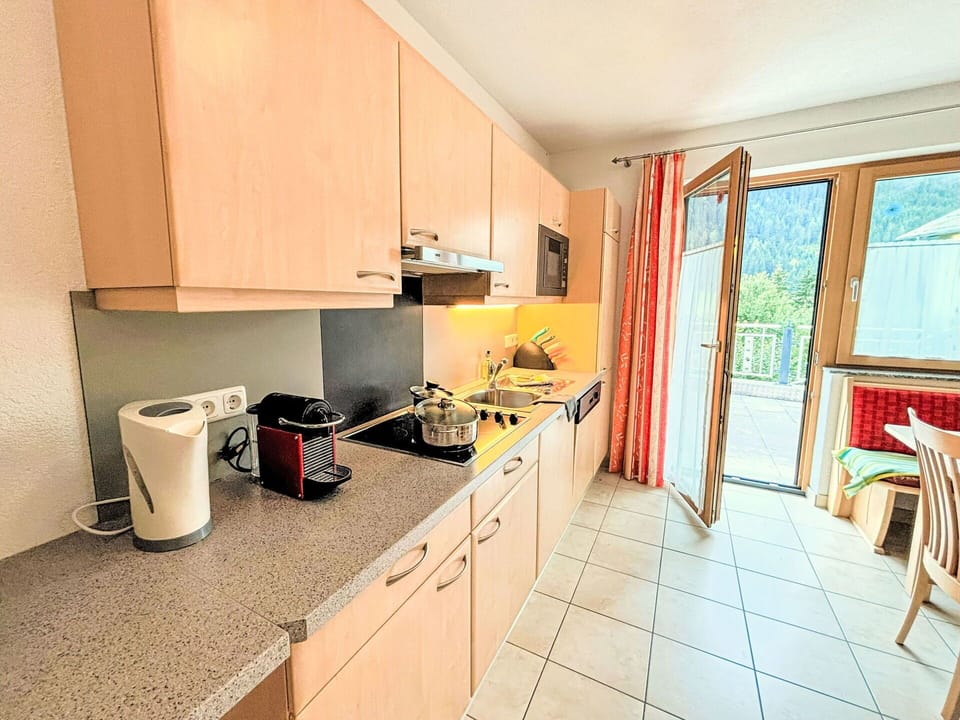 Cabinetry, Property, Window, Countertop, Kitchen Appliance, Kitchen, Kitchen Stove, Wood, Building, Interior Design