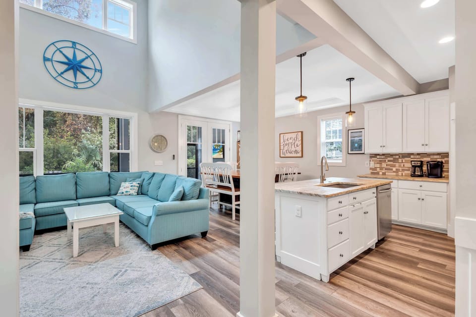 Unwind in the spacious family room, where the generous sectional invites you to sink in and relax. With a large TV as the focal point, this room is perfect for enjoying family game nights, watching sports, or simply catching up after a day in the sun