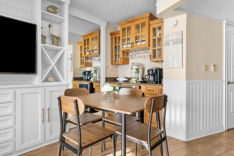 Dining table for 4, and a wet bar with coffee machine & margarita machine. 