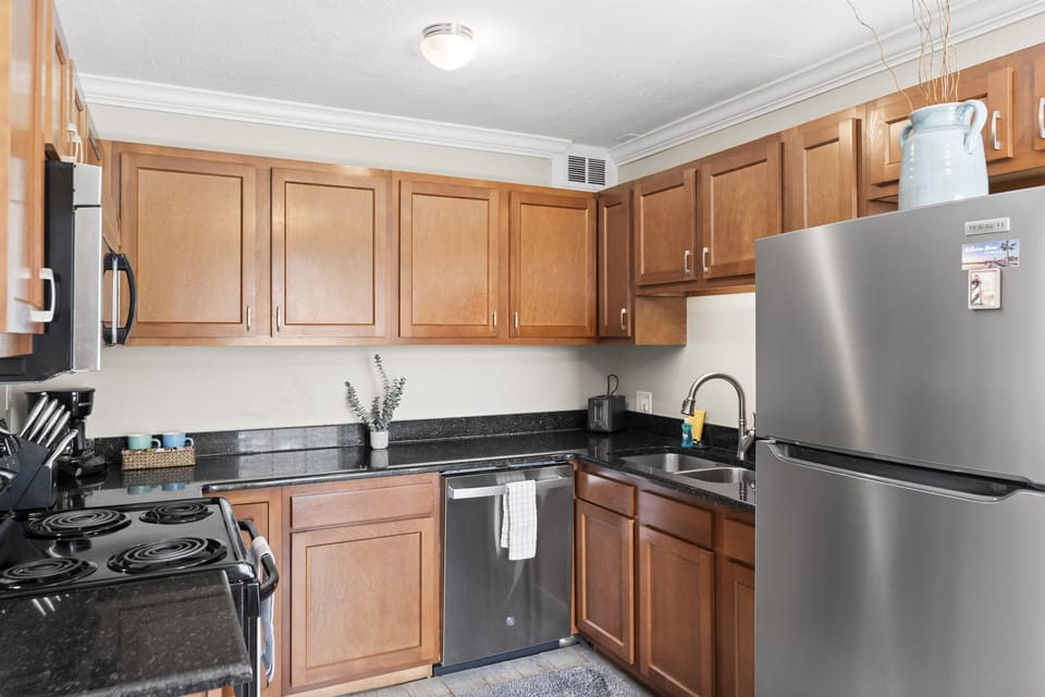 Cook up a feast in the fully equipped kitchen featuring modern appliances and cookware.