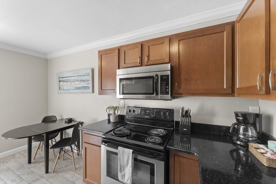 The kitchen features stainless steel appliances, cookware, and everything you need for easy in-home meals.
