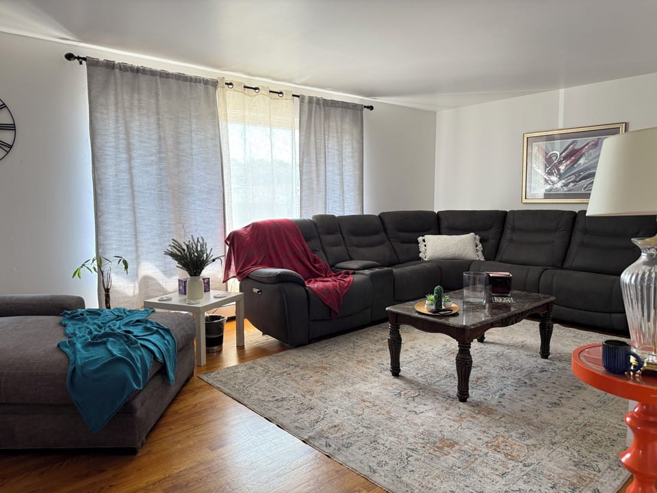 Bright and welcoming living room with plenty of natural light and a comfy sofa. 