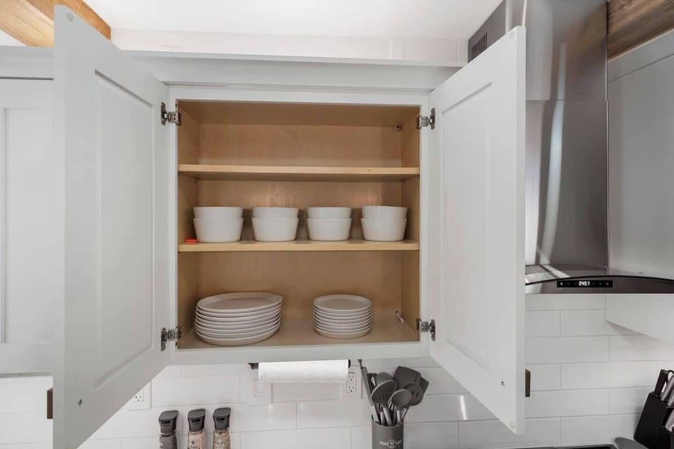 Suite 1 - Kitchen cabinet with a full set of bowls, large & small plates for up to 8.