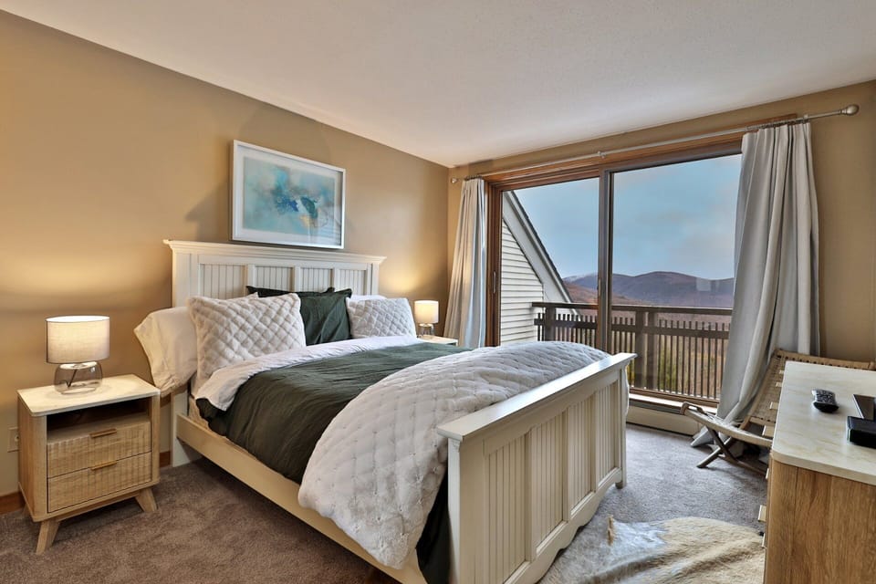 Open the curtains to mountain view, then step through the glass doors for a closer look from the deck.