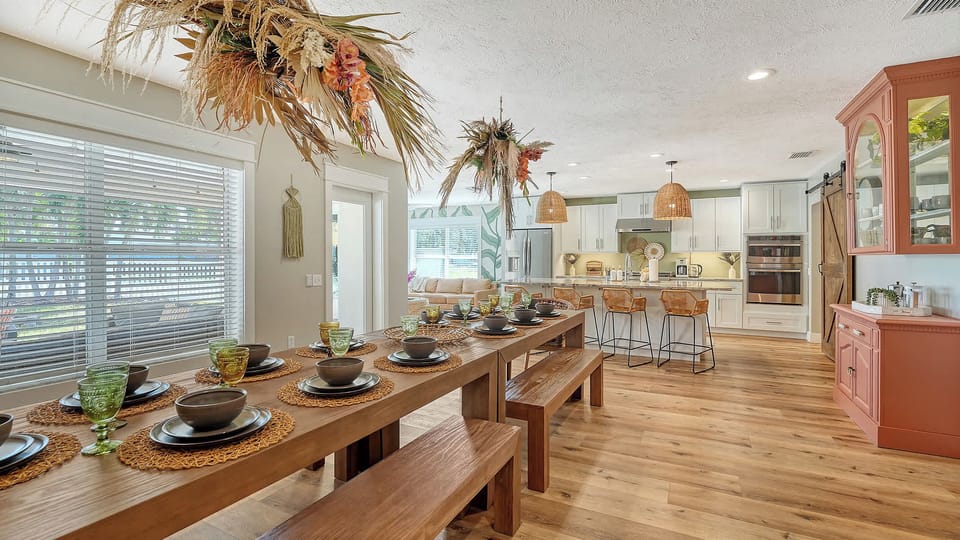 The open-concept kitchen, dining room, and sunroom create a bright, welcoming space for gathering. Cook in the fully equipped kitchen while staying connected with guests in the dining area or relaxing sunroom. 