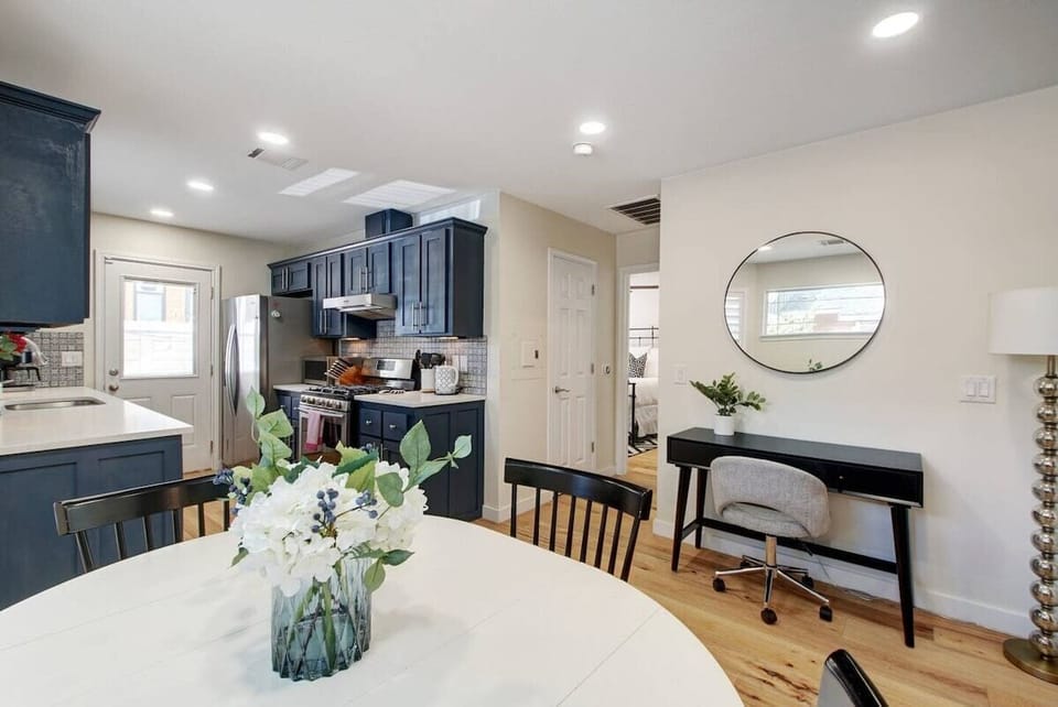 The hallway off the kitchen leads to the laundry room and primary bedroom/bathroom.