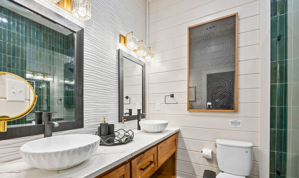 The ensuite bathroom features a beautiful vessel sink, stylish finishes, and plenty of space to get ready for the day ahead.