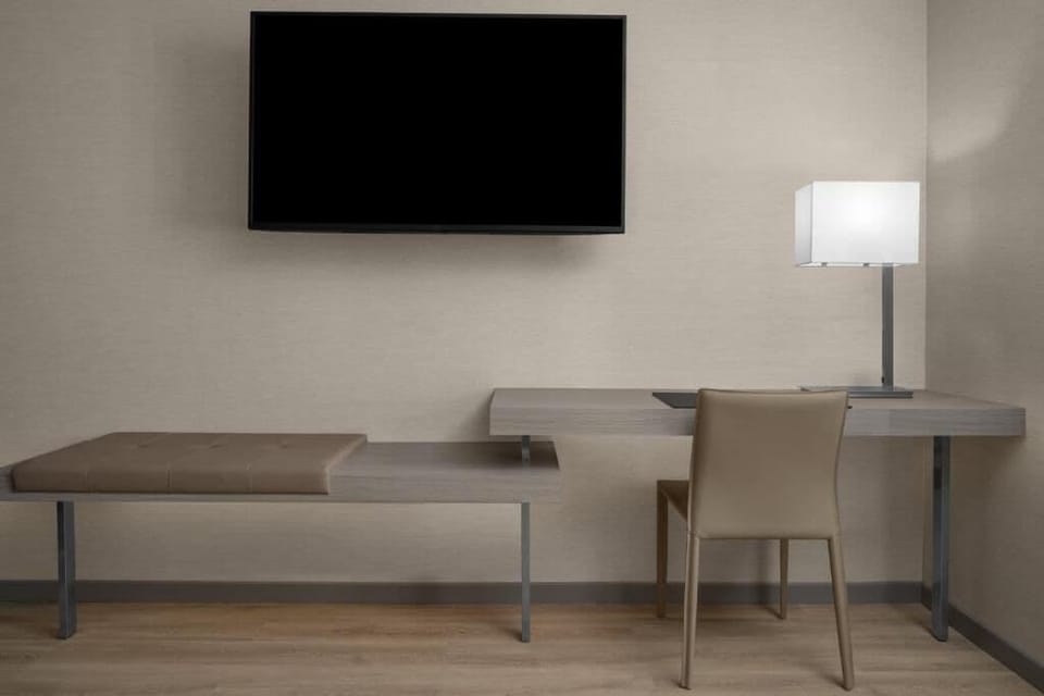 Work and unwind with a streamlined desk and large TV.