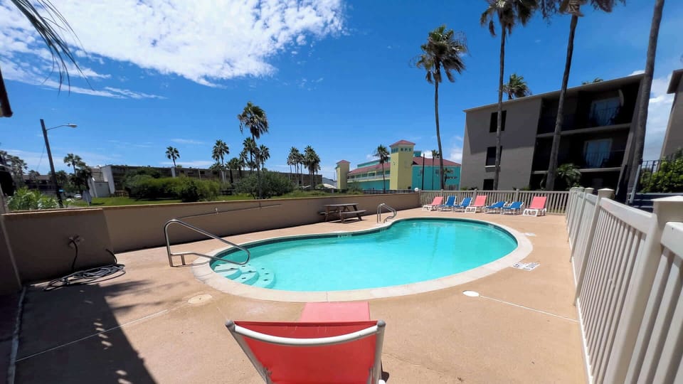 Relax by the sparkling outdoor pool with plenty of lounge chairs for sunbathing and a picnic table for poolside meals. Perfect for cooling off after the beach or enjoying a laid-back afternoon in the sun.