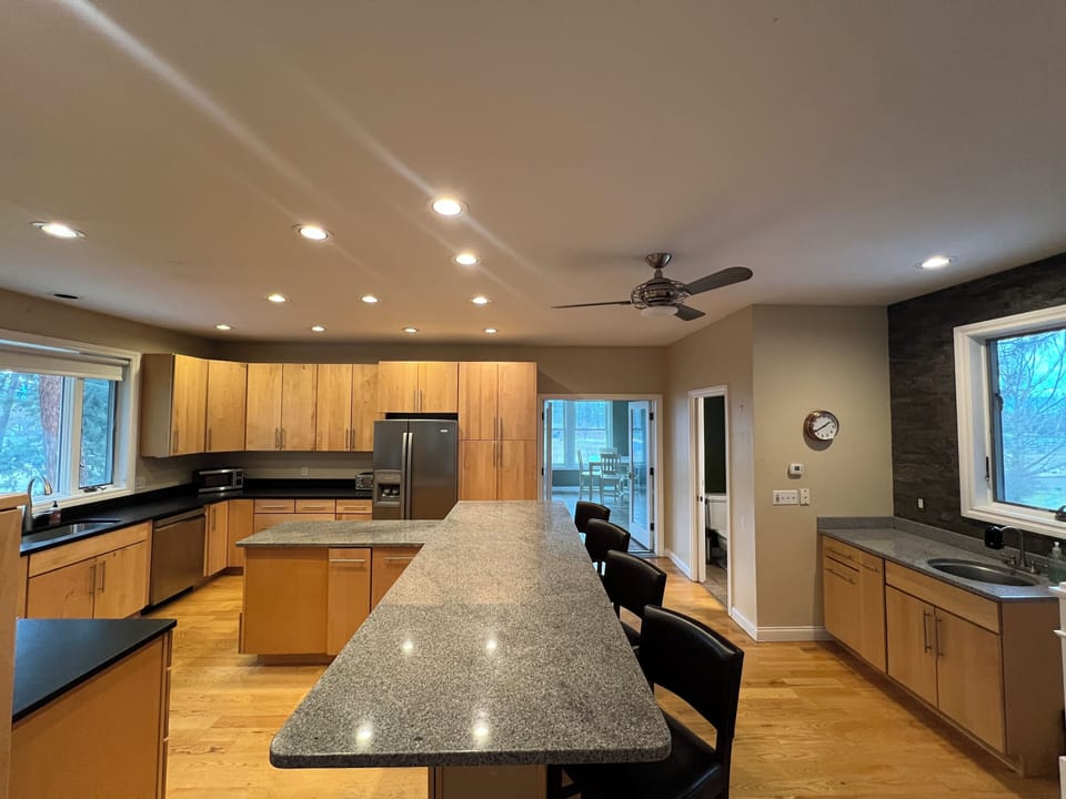 Kitchen, looking into sunroom, wet bar to the right.