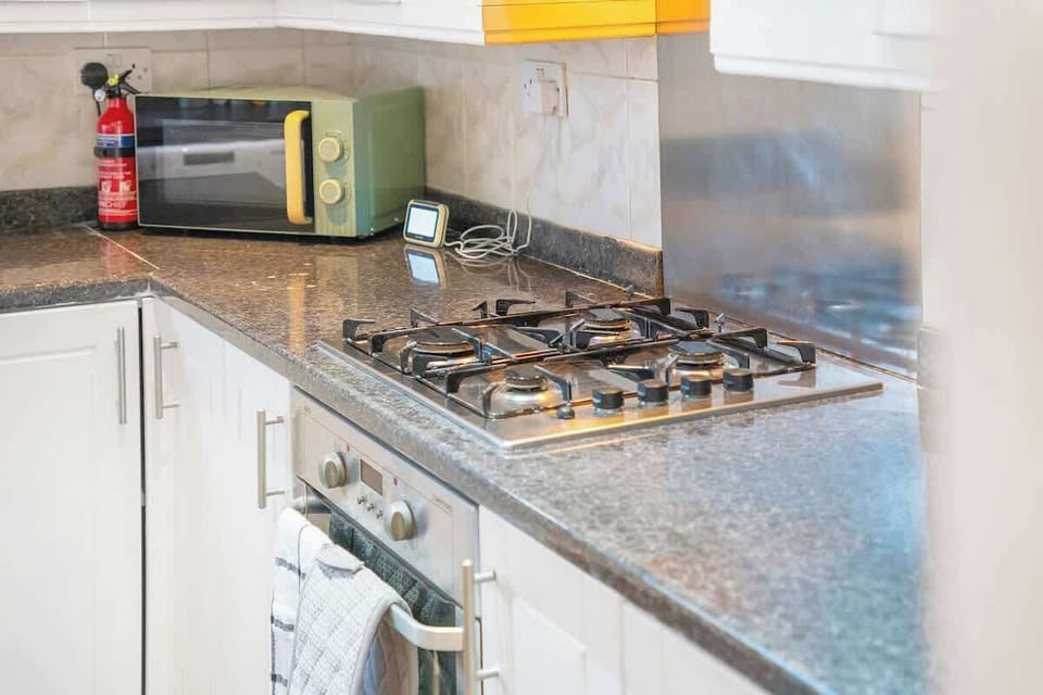 Kitchen equipped with all essentials, including a washer & dryer, oven, fridge and full cookware set.