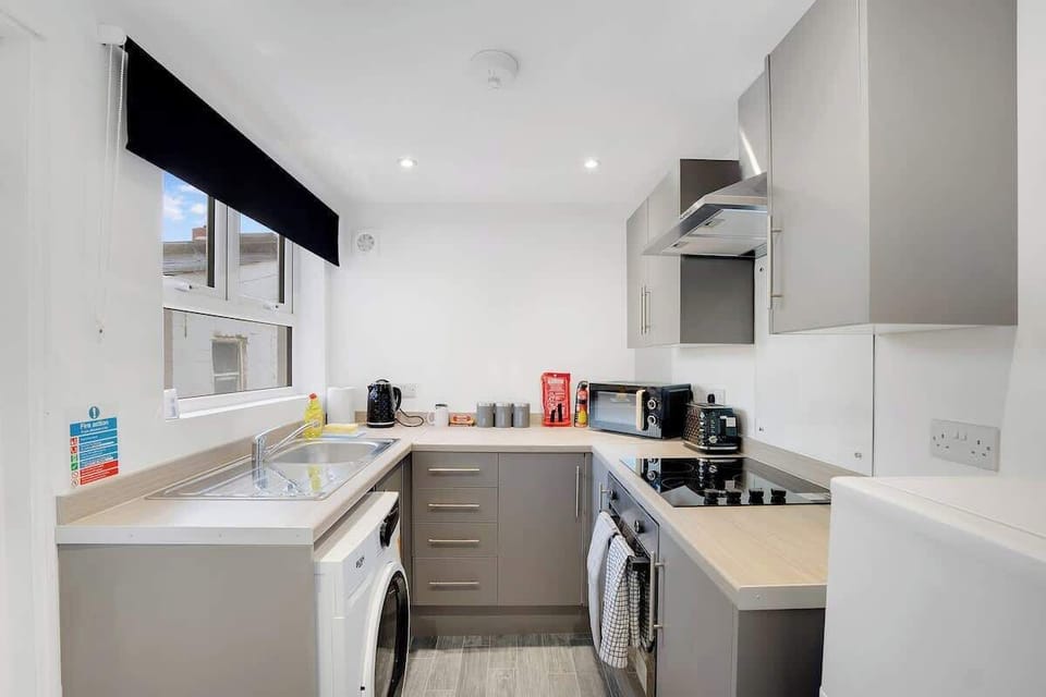 Kitchen equipped with all essentials, including a washer & dryer, oven, fridge and full cookware set.
