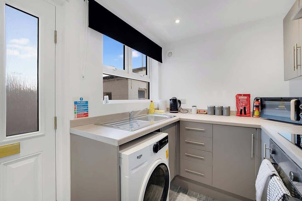 Kitchen equipped with all essentials, including a washer & dryer, oven, fridge and full cookware set.
