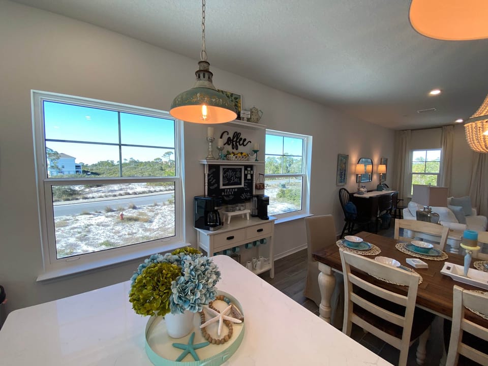Oh, the views! Fully stocked kitchen sits adjacent to the main living area