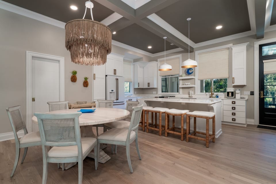 The dining area sits between the kitchen and living area of the home.  The dining table has seating for 6