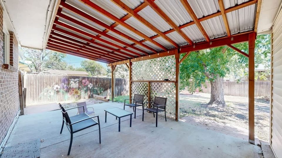 The huge back patio offers plenty of space to relax and unwind, perfect for outdoor dining, entertaining, or simply enjoying the fresh air.