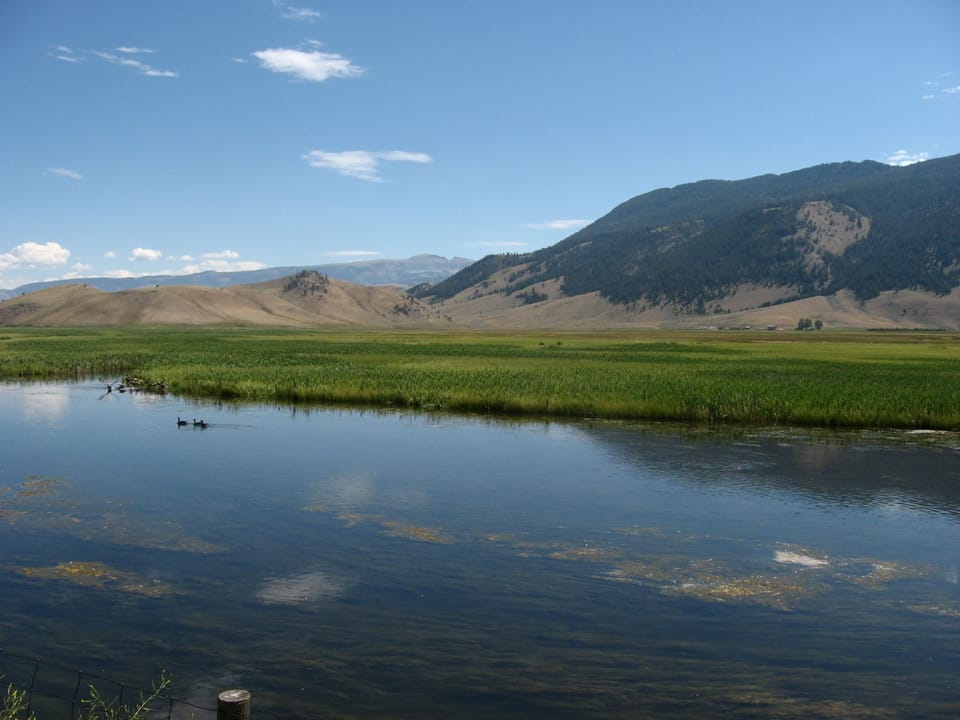 Unwind beside glassy waters with wide-open valley views.