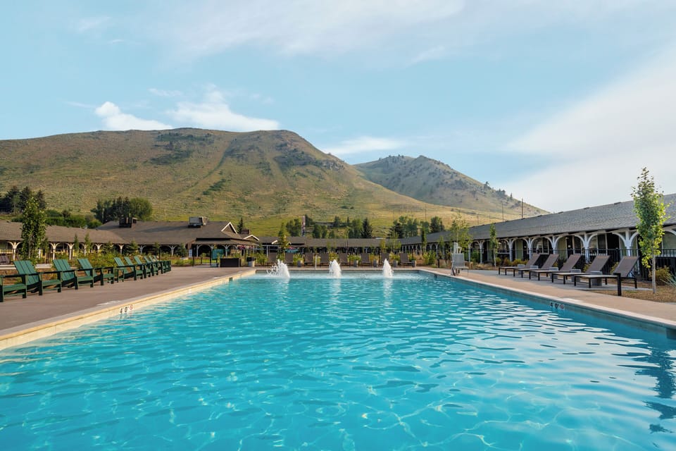 Dive into sparkling pool waters with sweeping mountain views.