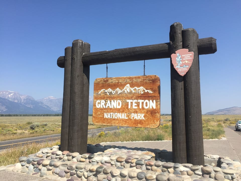 Start your adventure at the iconic Grand Teton entrance sign.